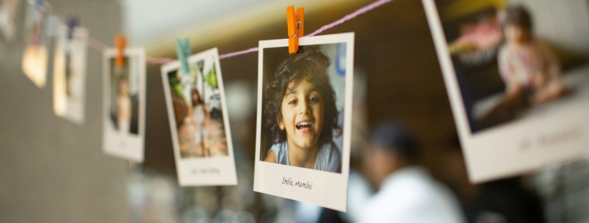 Instant photos of children hanging on a string